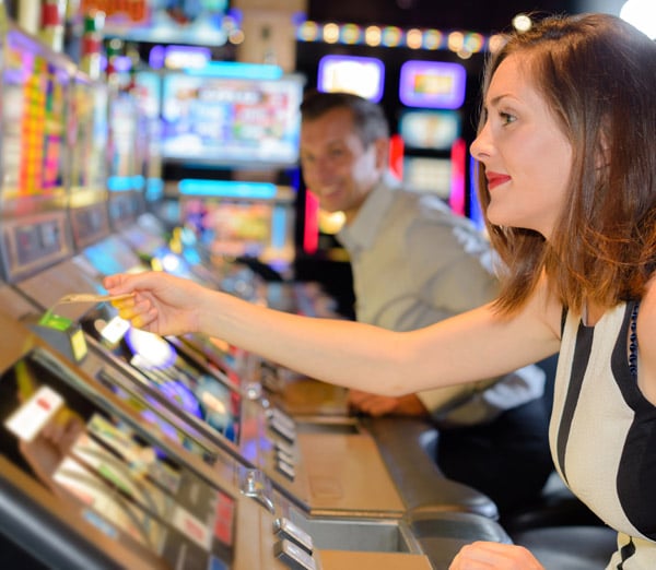 Woman taking a voucher from a gaming machine