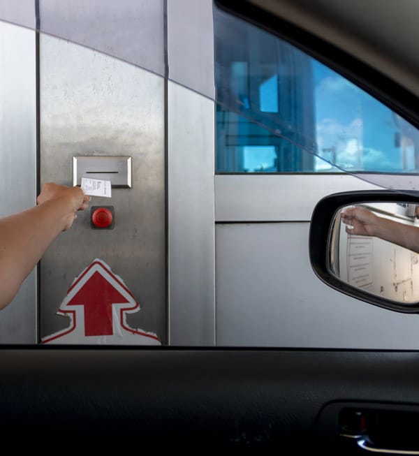 Man taking a toll booth ticket