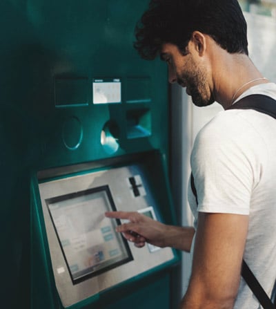 A man using a ticketing kiosk