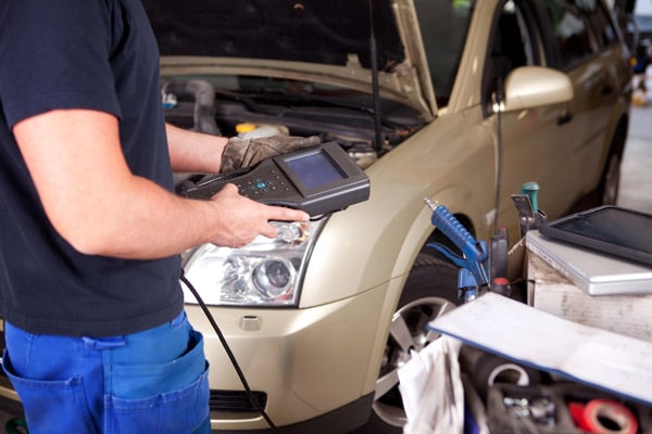 Mechanic using a vehicle diagnostic tool