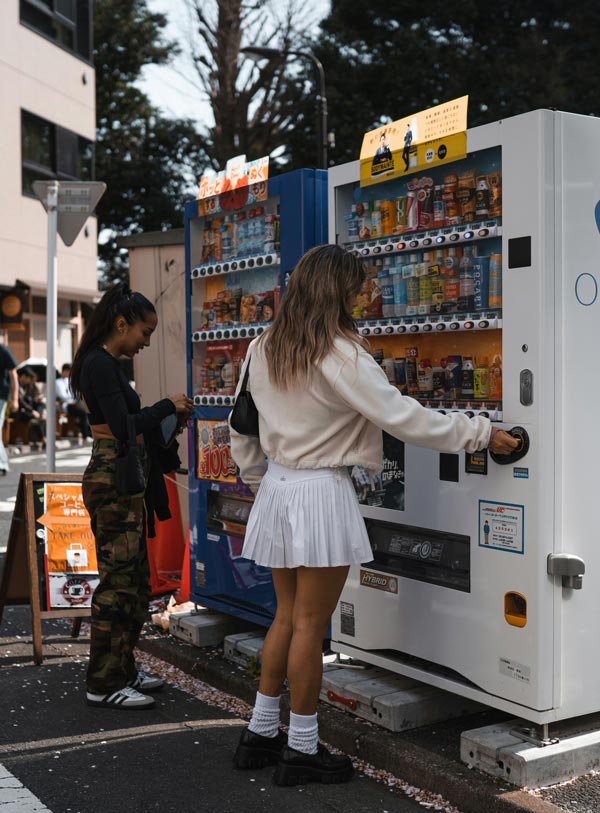 Women using vending machines equipped with a thermal printer